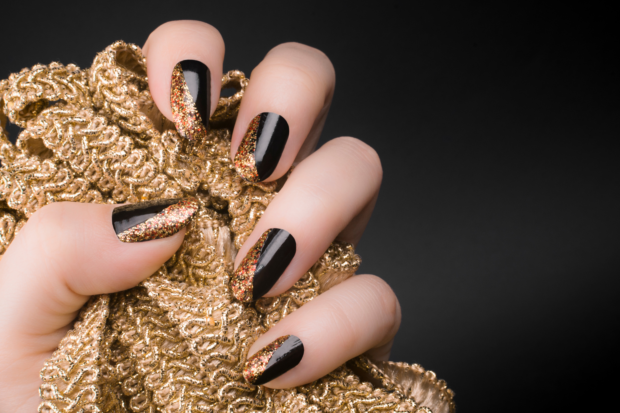 Person's Hand with Golden Black Nails