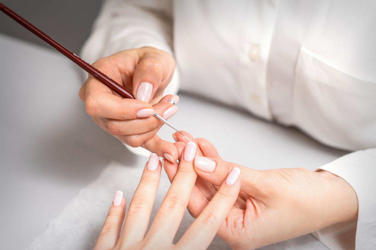 Manicurist Drawing Nail with Thin Brush